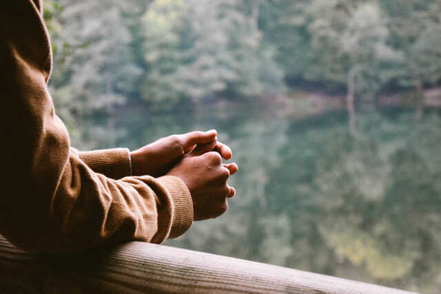 Image of hands with lake background