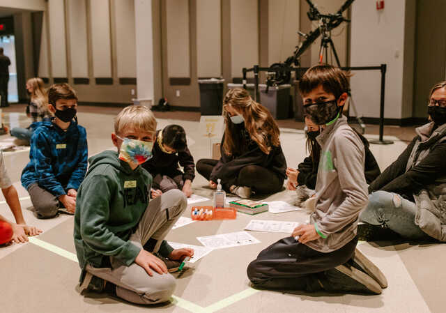 upstreet children wearing masks in small group