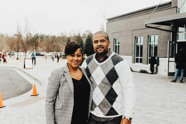 couple standing outside church building