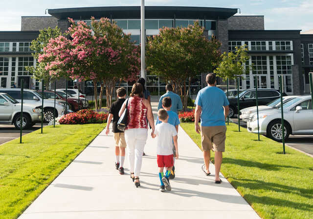 family walking into the north point community church building